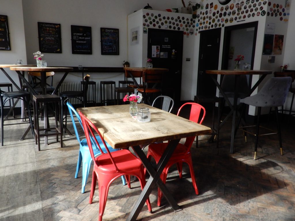 Tables and seating in the Perfect Hive downstairs bar.