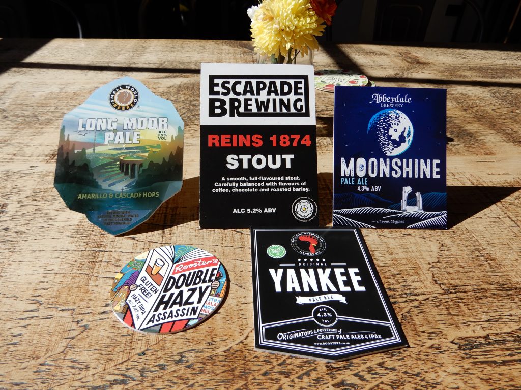 A selection of beer badges on the Perfect Hive bar.